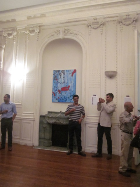 the artist (2nd from right) takes a shot of his visitors